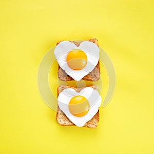 Heart shaped egg in tosted slice of rye bread. Love breakfast design. Healthy sandwich. Festive lunch or breakfast. Egg