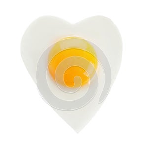 Heart shaped fried egg isolated on white