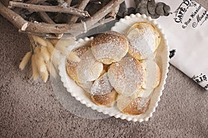 Heart shaped fritters with icing in a plate