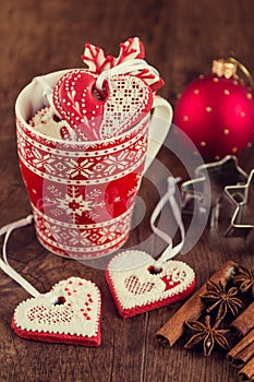 Heart shaped gingerbread cookies on red cup with christmas decor