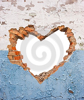 Heart shaped hole in old brick wall