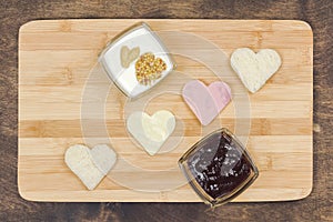 Heart shaped hot sandwich recipe, ingredients with sauces on a wooden board