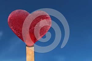 Heart shaped ice in front of the summer sky