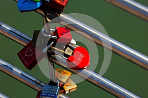 Heart-shaped lock symbolizing love and commitment on metal rails