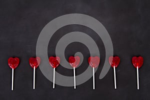 Heart shaped lollipops on a chalkboard