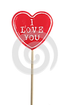 Heart shaped lolly pop on white background photo