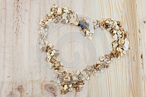 Heart-shaped muesli and cereal on the wooden table