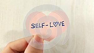 A heart shaped note with the words Self-Love