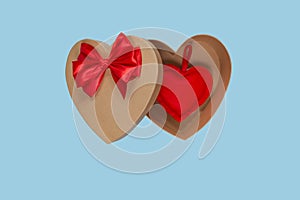 Heart shaped open gift box with a red bow on a blue background with a heart inside. Isolate. Valentine`s Day Gift