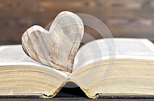 Heart shaped ornament and an old book