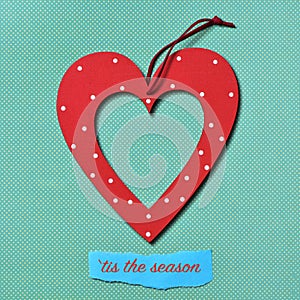 Heart-shaped ornament and text tis the season