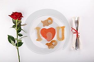 Heart shaped pancakes on white plate. I love you.  Festive breakfast on white table. Love concept. Happy Valentineâ€™s day. Top