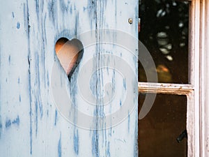 Heart shaped pattern carved in a wooden shutter