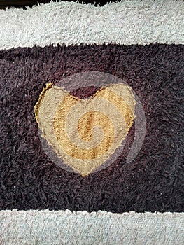 Heart-Shaped Pattern on Textured Dark and Light Fabric Close-Up