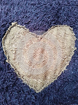 Heart-Shaped Pattern on Textured Dark and Light Fabric Close-Up