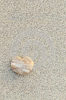 Heart shaped pebble on the beach