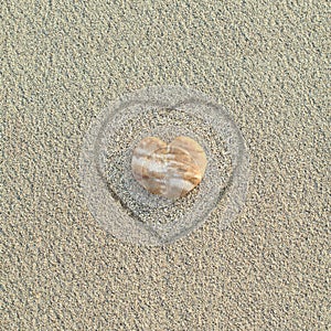 Heart shaped pebble on the beach