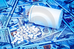 Heart-shaped pills on the background of hundred-dollar bills. The concept of the expensive cost of healthcare or financing