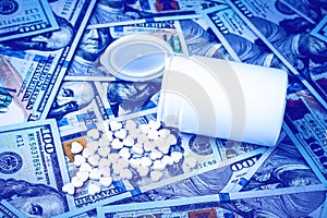 Heart-shaped pills on the background of hundred-dollar bills. The concept of the expensive cost of healthcare or financing