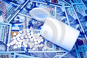 Heart-shaped pills on the background of hundred-dollar bills. The concept of the expensive cost of healthcare or financing