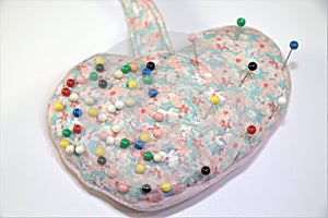 Heart shaped Pin cushion with pins on white