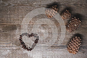 Heart shaped pine nuts on wooden background