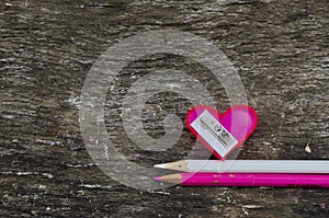 Heart-shaped pink pencil sharpener and two pencils