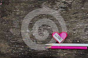 Heart-shaped pink pencil sharpener and two pencils