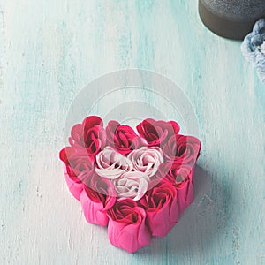 Heart shaped pink red roses on pastel color