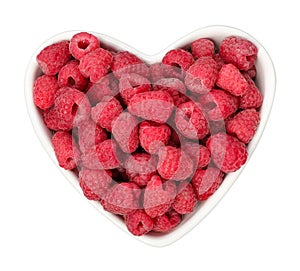 Heart-shaped plate of fresh ripe raspberries, top view