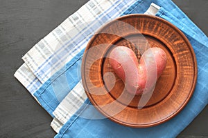 heart-shaped potatoes on a bowl, top view, flat lay. preference natural products. photo