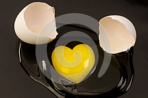 Heart shaped raw egg yolk