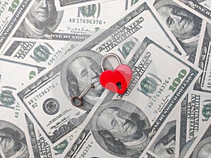Heart shaped red lock with key and banknotes.Concept of love money forever