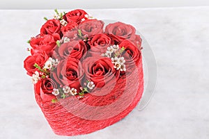 Heart shaped red roses on white background