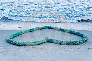 Heart-shaped rope on the beach