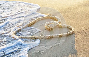 Heart-shaped rope on the beach