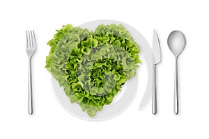 Heart-shaped salad, lettuce with fork, spoon, knife