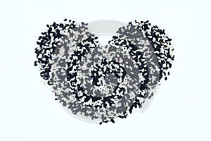 Heart shaped sesame seeds on white