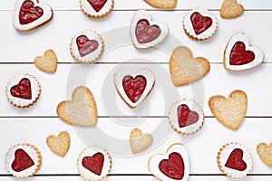 Heart shaped and shortbread cookies with jam gift composition for Valentines Day on vintage wooden background.