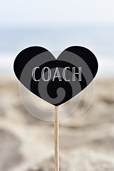 Heart-shaped signboard with text coach