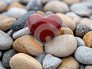 heart-shaped stone on pebbles