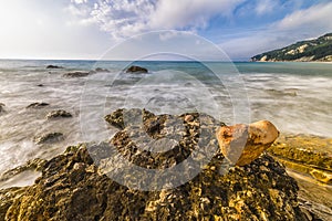 Heart-shaped stone at the Rocce nere beach at sunrise, Conero NP photo