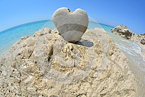 Heart shaped stone on white rock