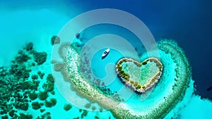 heart shaped tropical island reef with boat, aerial view symbolizing love, with empty negative space