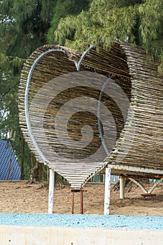 Heart-shaped wooden platform building on the beach by the sea