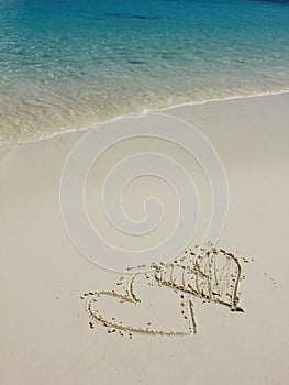 Heart shapes on white sand beach