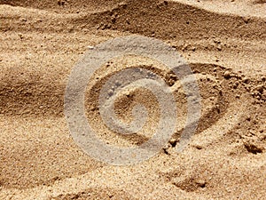 HEART sign made with sand on a beach