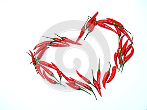 heart sign of red chili peppers on a white background. blank for designers. free space