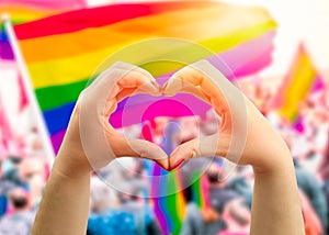 Heart sign and wave in front of a rainbow flag