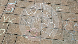 Heart sketches with the text love yourself - chalk drawing on stone pavement